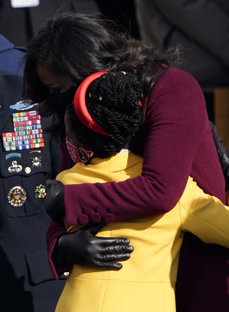 Former first lady Michelle Obama embraces poet Amanda Gorman at the inauguration ceremony on Jan. 20, 2021.