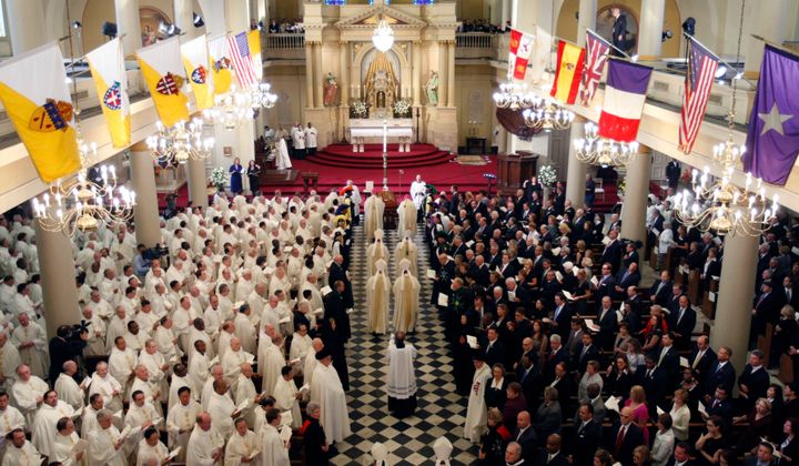 Clergy attend a funeral Mass inside the St. Louis Cathedral in New Orleans, Thursday, Oct. 6, 2011. The New Orleans archdiocese, along with its parishes and schools, collected more than $26 million in paycheck money.