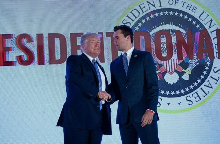 President Donald Trump shakes hands with Charlie Kirk, head of Turning Point USA, before addressing the group's Teen Student Action Summit in Washington, D.C., on July 23, 2019.