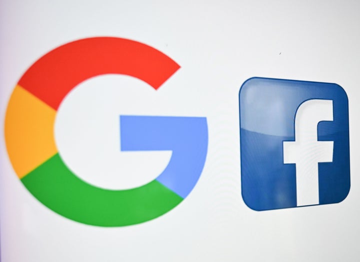 A photo taken on Oct. 21, 2020 shows the logos of Google and Facebook.