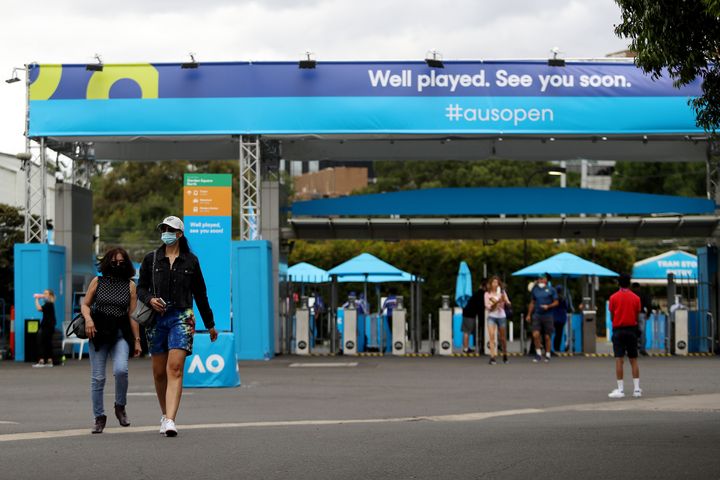 Spectators arrive wearing face masks at Melbourne Park on Friday in Melbourne.