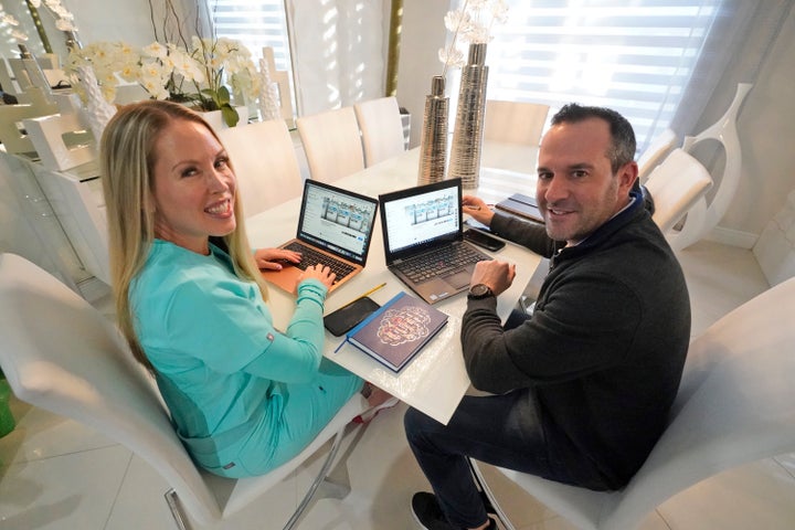 Katherine Quirk, left and her husband, Russ Schwarz, pose for photos on Jan. 28, 2021, at their home in Parkland, Fla. The tw