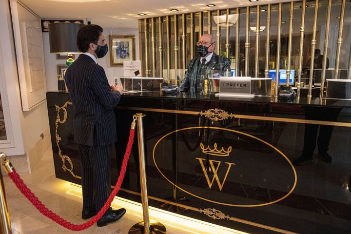 Screens protect staff at the reception desk at the Wellington Hotel in Madrid, Spain