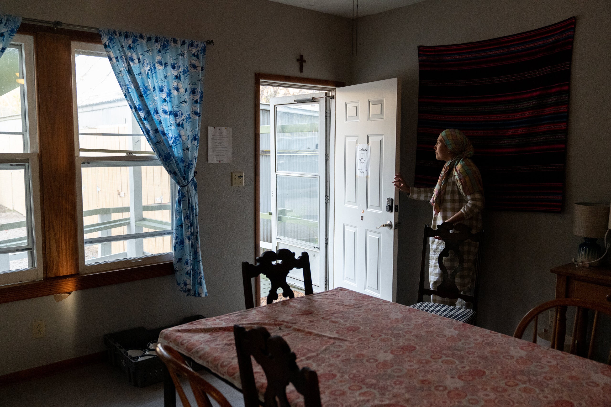 In this Feb. 4 photo, Aida opens the door of the San Antonio shelter where she and her children are staying.