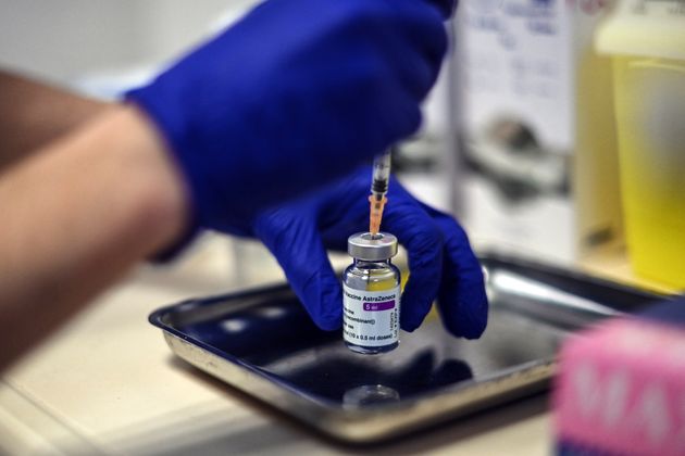 A nurse prepares a dose of the AstraZeneca COVID-19 vaccine at the Edouard Herriot hospital on