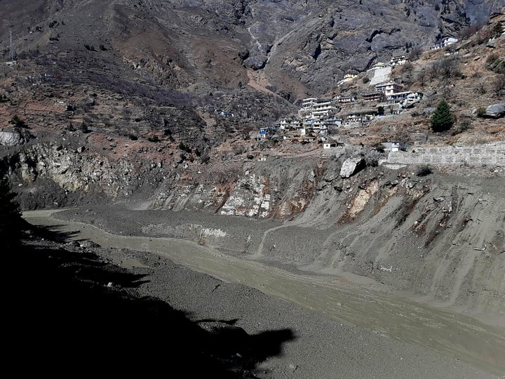 Mud and slash are seen in the Dhauliganga River after a portion of Nanda Devi glacier broke off in Tapovan area of the northern state of Uttarakhand.