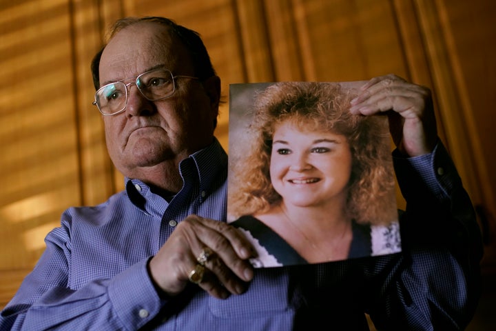 Mortuary owner Brian Simmons holds a photo of his daughter Rhonda Ketchum who died before Christmas of COVID-19, Thursday, Jan. 28, 2021, in Springfield, Mo. (AP Photo/Charlie Riedel)