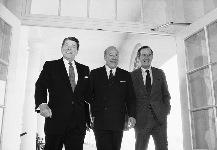 Secretary of State George Shultz, center, walks with President Reagan and Vice President George Bush on his arrival on Wednesday, Jan. 9, 1985 at the White House in Washington after two days of arms talks with the Soviet Union in Geneva. (AP Photo/Barry Thumma)