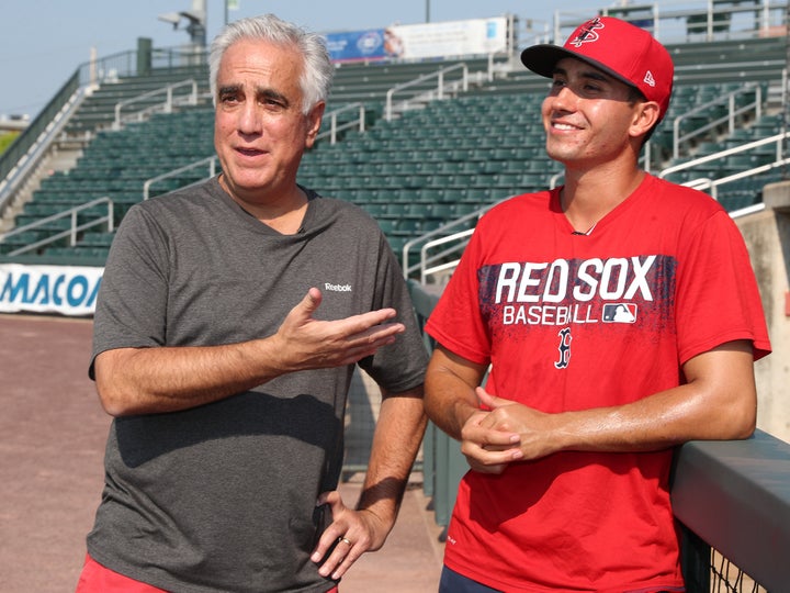 ESPN's Pedro Gomez, left, stands with his son Rio Gomez, who was a rookie pitcher in 2018. 