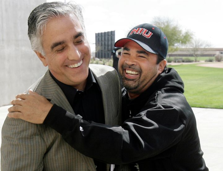 Chicago White Sox' manager Ozzie Guillen, right, jokes with ESPN's Pedro Gomez after a news conference in 2008.