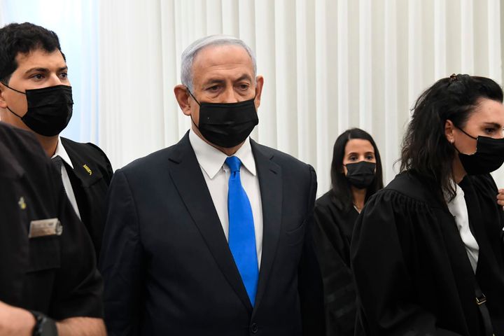 Israeli Prime Minister Benjamin Netanyahu stands at a hearing at the district court in Jerusalem, on Feb. 8, 2021. 