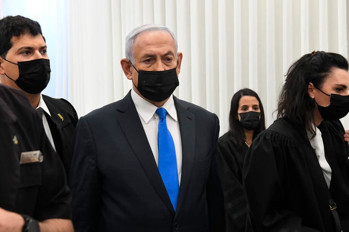Israeli Prime Minister Benjamin Netanyahu stands at a hearing at the district court in Jerusalem, on Feb. 8, 2021. 