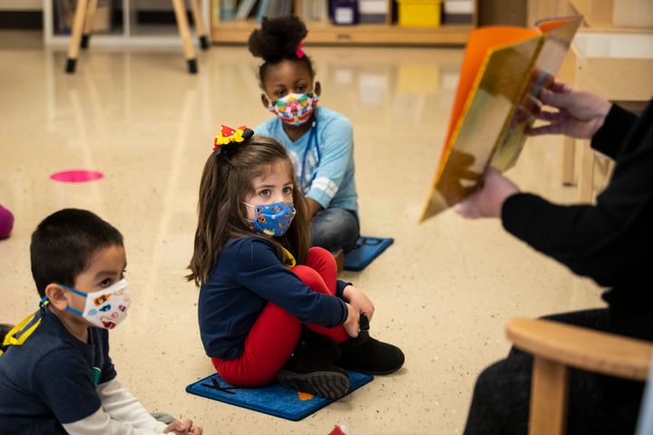 Pre-kindergarten students listen as their teacher reads a story at Dawes Elementary in Chicago, Monday, Jan. 11, 2021. (Ashlee Rezin Garcia/Chicago Sun-Times via AP, Pool)