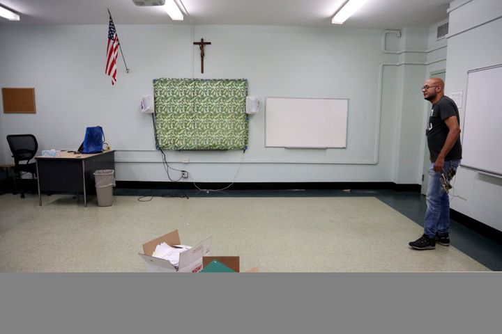 Facilities manager Charles Fabian stands in an empty classroom at Queen of the Rosary Catholic Academy in Brooklyn, New York,