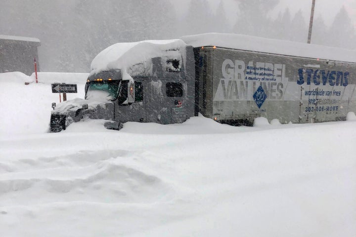 A tractor-trailer is stuck in heavy snowfall near Mono County, California, on Jan. 27. An atmospheric river storm pumped dren