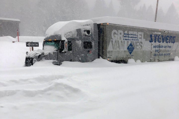 A tractor-trailer is stuck in heavy snowfall near Mono County, California, on Jan. 27. An atmospheric river storm pumped drenching rains into the heart of California as blizzard conditions buried the Sierra Nevada in snow.