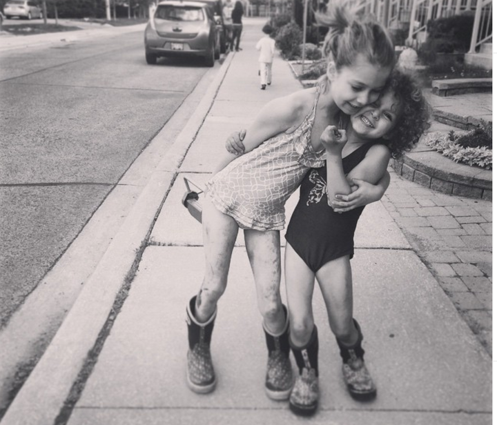 The photographer's daughters, in an impromptu muddy cuddle, snapped on a cellphone.