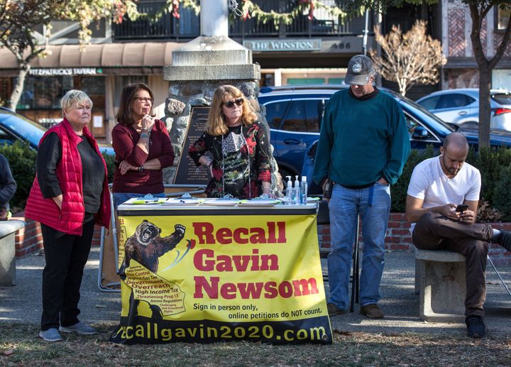 People circulate a "Recall Gavin Newsom" petition in Solvang, California, during a pro-Donald Trump rally. 