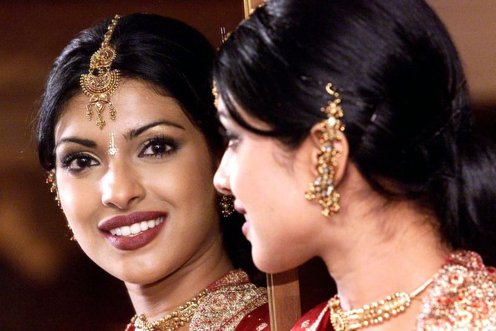 Miss India Priyanka Chopra, then 18, poses for the cameras at the official Miss World photocall in London in 2000.