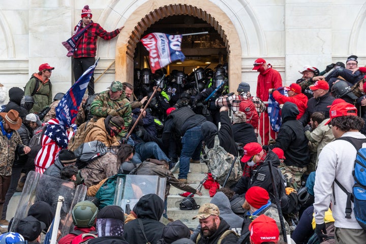 Pro-Trump insurrectionists attack police officers protecting an entrance to the U.S. Capitol on Jan. 6, 2021.