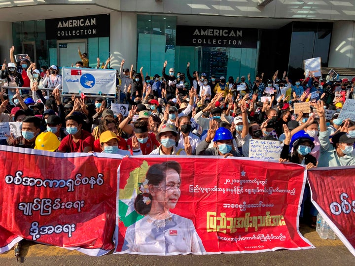 Demonstrators display three-fingered salute, a symbol of resistance at an intersection in Yangon, Myanmar Wednesday, Feb. 10, 2021. Protesters continued to gather Wednesday morning in Yangon breaching Myanmar's new military rulers' decrees that effectively banned peaceful public protests in the country's two biggest cities. (AP Photo)