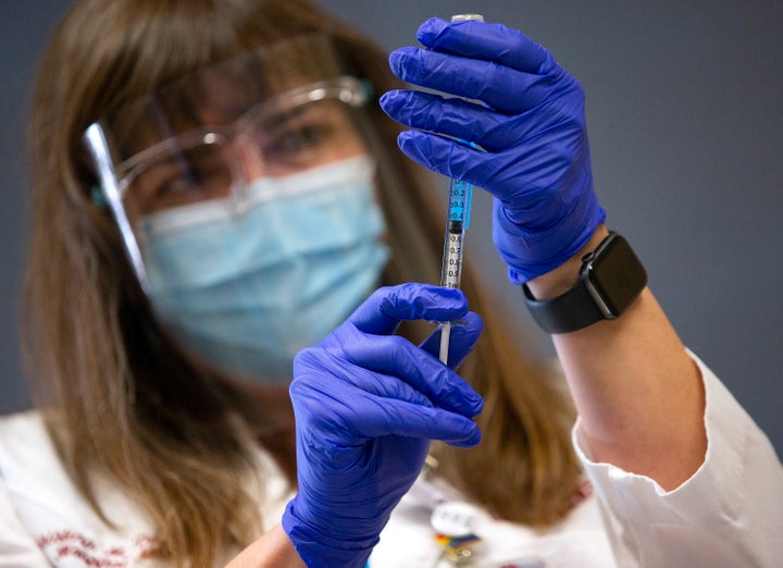 Maine Medical Center staff receiving their first doses of the COVID-19 vaccine in December. The hospital is now trying to persuade nurses not to unionize.