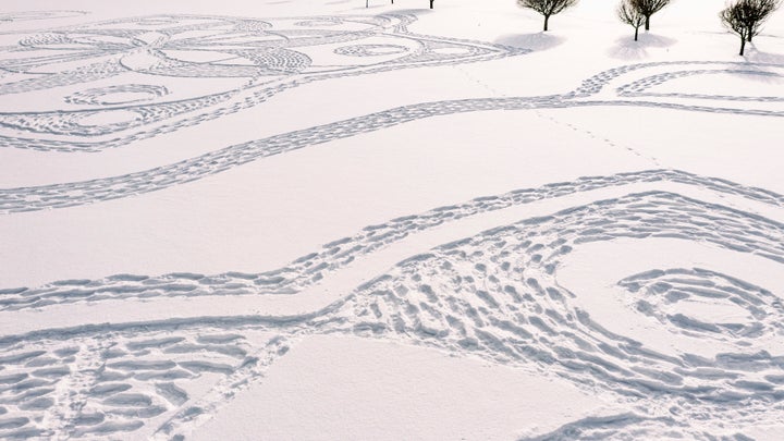 Part of a giant complex geometric pattern formed from thousands of footsteps in the snow in Espoo, Finland, Monday Feb. 8, 20