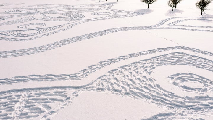 Part of a giant complex geometric pattern formed from thousands of footsteps in the snow in Espoo, Finland, Monday Feb. 8, 2021. The art work design measuring about 160 meters in diameter was made by volunteers in snowshoes under the guidance of local resident and amateur artist Janne Pyykko, but the ephemeral work will only last until the next snowfall or heavy winds. (Pekka Lintusaari via AP)