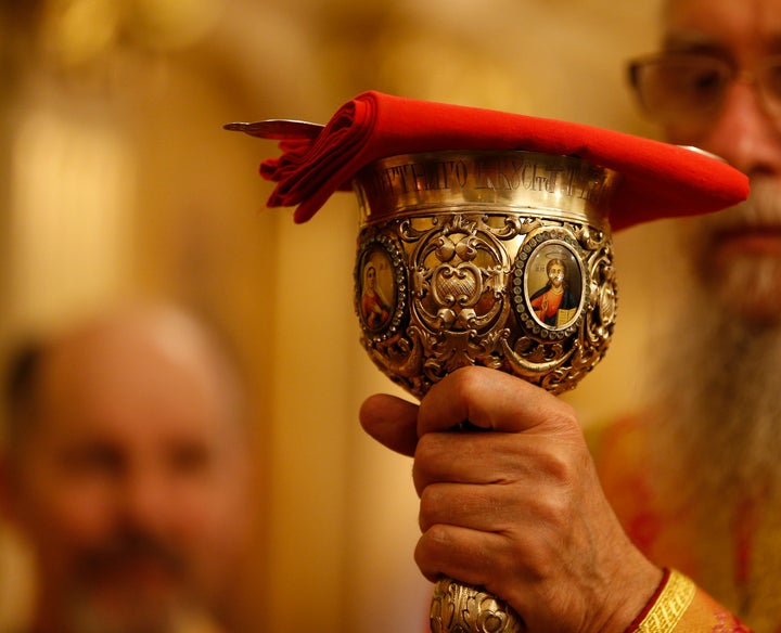 Belarus, Gomel city, celebrating the church holiday of Easter in St. Nicholas Monastery 01.05. 2016 year. The priest holds the chalice church