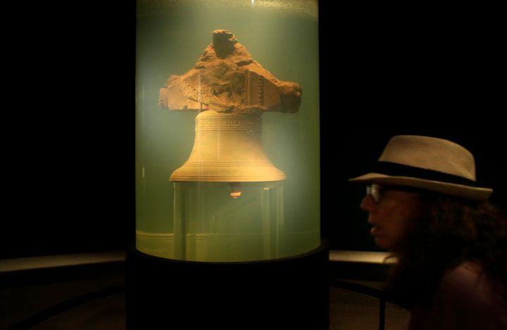 In this 2016 file photo, a museum visitor walks by a display of a bell once belonging to the pirate ship Whydah Gally at the Whydah Pirate Museum, in Yarmouth, Mass. 