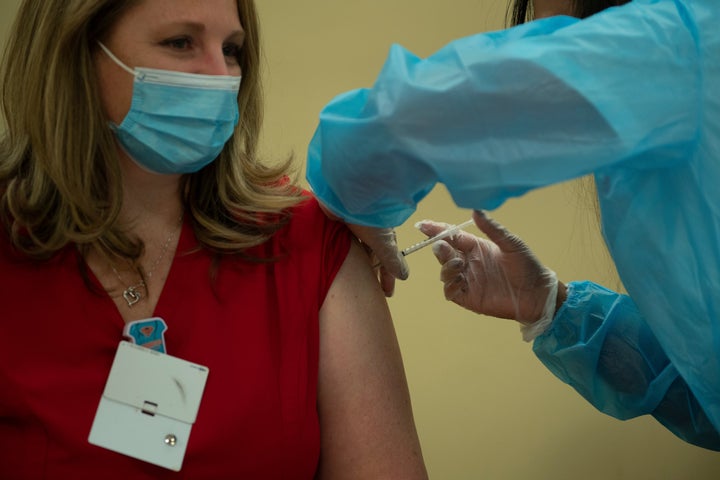 A person receives the Pfizer COVID-19 vaccine at the Goodwin House Bailey's Crossroads, a senior living community in Falls Church, Virginia, on Dec. 30, 2020.