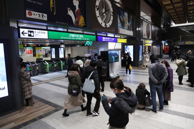 People stand in front of the ticket gates at JR Sendai Station in Sendai on February 13, 2021 after a strong 7.1-magnitude earthquake struck late off the eastern coast of Japan but no tsunami warning was issued, Japanese authorities said. (Photo by - / JIJI PRESS / AFP) / Japan OUT (Photo by -/JIJI PRESS/AFP via Getty Images)