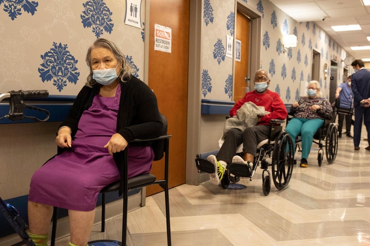 Nursing home residents make a line for the coronavirus disease (COVID-19) vaccine at Harlem Center for Nursing and Rehabilitation, a nursing home facility, on Friday, Jan. 15, 2021 in Harlem neighborhood of New York. (AP Photo/Yuki Iwamura)