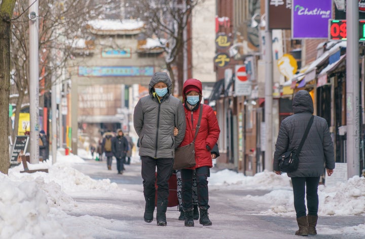 A couple walks in Chinatown during the COVID-19 pandemic in Montreal, on Monday, January 18, 2021. 