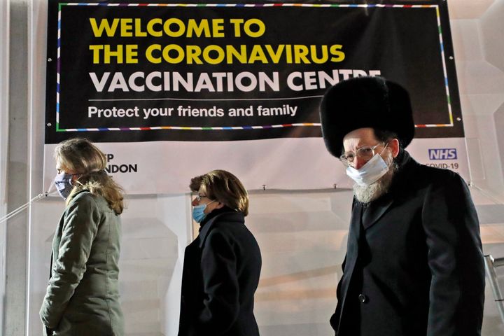 People from the Haredi Orthodox Jewish community arrive at an event to encourage vaccine uptake in the ultra-Orthodox community at the John Scott Vaccination Centre in London on Saturday.