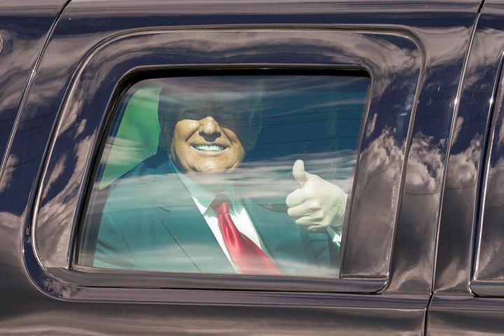 President Donald Trump gestures to supporters en route to his Mar-a-Lago Florida Resort on Jan. 20, 2021, in West Palm Beach, Fla. 
