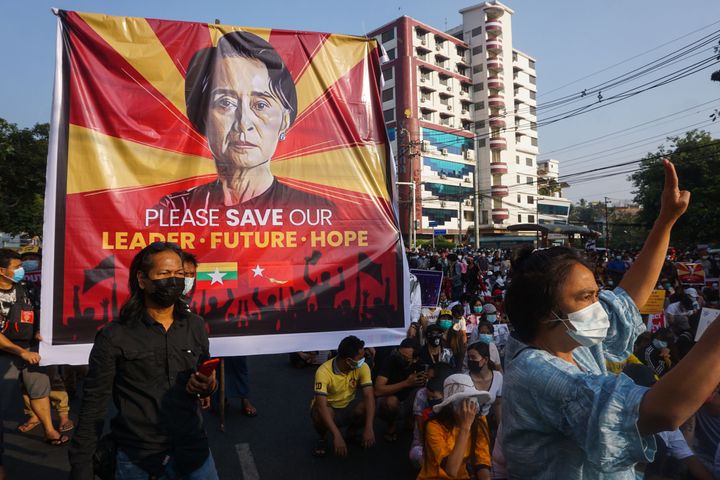A banner featuring Aung San Suu Kyi is displayed as protesters take part in a demonstration against the military coup in front of the National League for Democracy (NLD) office in Yangon on Feb. 15, 2021. 