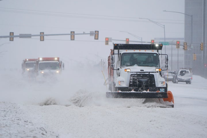 Snowplows works to clear the road during a winter storm Sunday, Feb. 14, 2021, in Oklahoma City. (AP Photo/Sue Ogrocki)