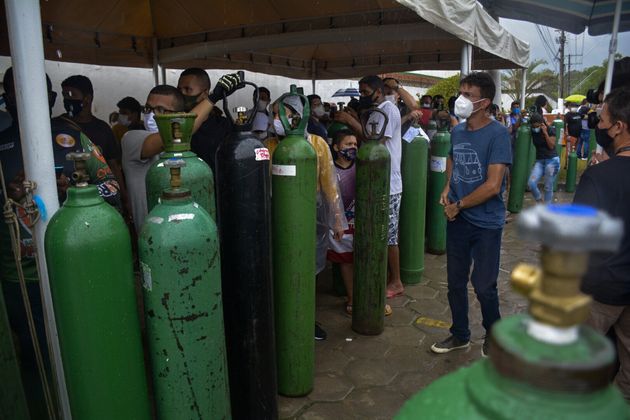 Relatives of patients infected with Covid-19 queue for long hours to refill their oxygen tanks in Manaus, Brazil.