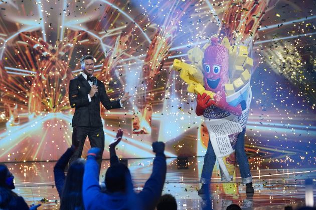 Joel Dommett celebrating Sausage's Masked Singer win