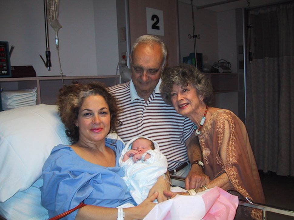 Joanna Gualtieri pictured with her mother and father after giving birth to son Sebastien.