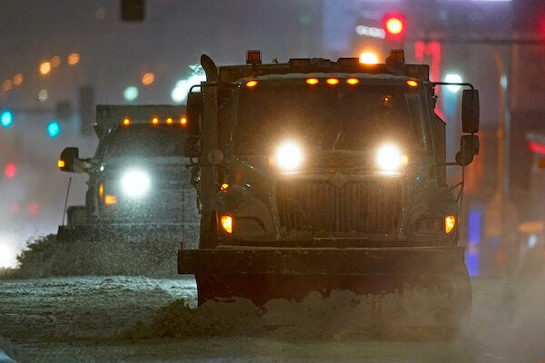 Snow plows clear a street in Kansas City, Mo., as temperatures drop below 0 degrees Fahrenheit on Monday.