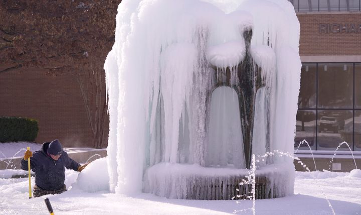 City of Richardson worker Kaleb Love works to clear ice from a water fountain Tuesday, Feb. 16, 2021, in Richardson, Texas. (AP Photo/LM Otero)