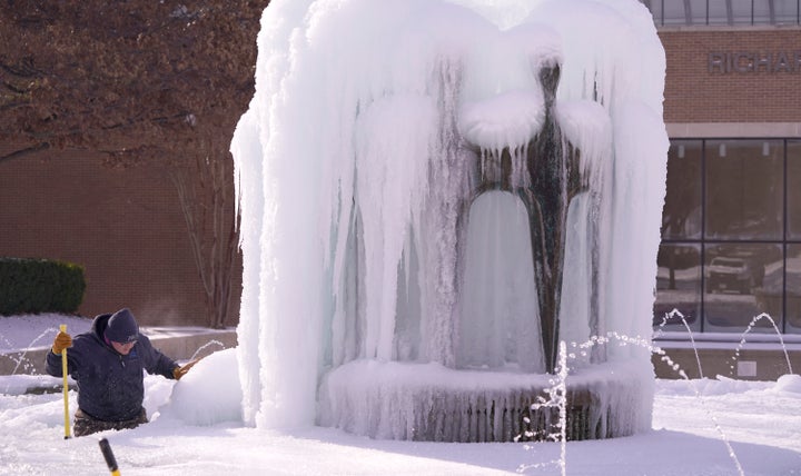 City of Richardson worker Kaleb Love works to clear ice from a water fountain Tuesday, Feb. 16, 2021, in Richardson, Texas. (
