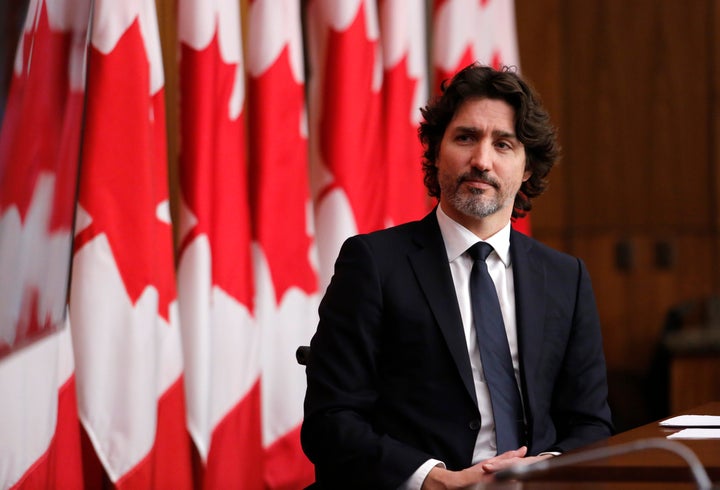 Prime Minister Justin Trudeau listens at a press conference in Ottawa on Feb. 16, 2021.