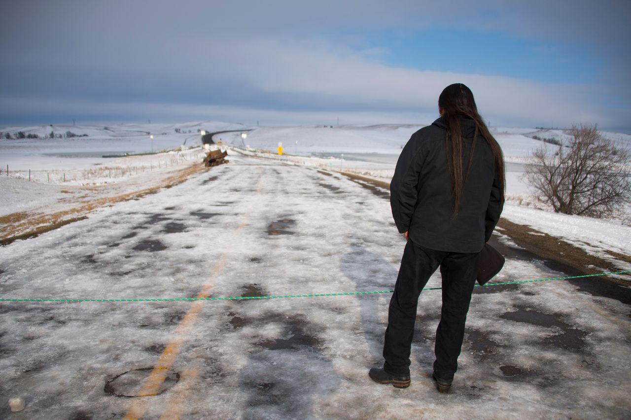 Activist Pete Sands of the Navajo Nation looks out over an area set as a borderline where the police guard a bridge near Oceti Sakowin Camp on the edge of the Standing Rock Sioux Reservation on Dec. 3, 2016, outside Cannon Ball, North Dakota.