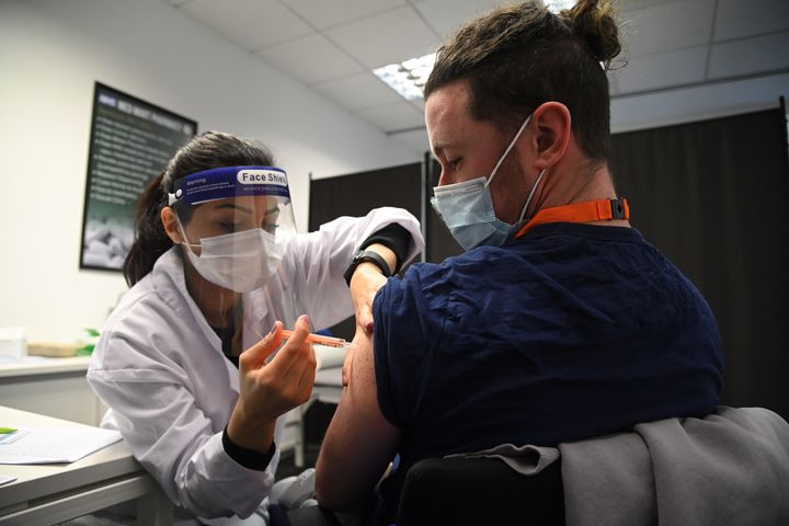 A care worker receives the Oxford-AstraZeneca Covid-19 vaccine in Borehamwood.