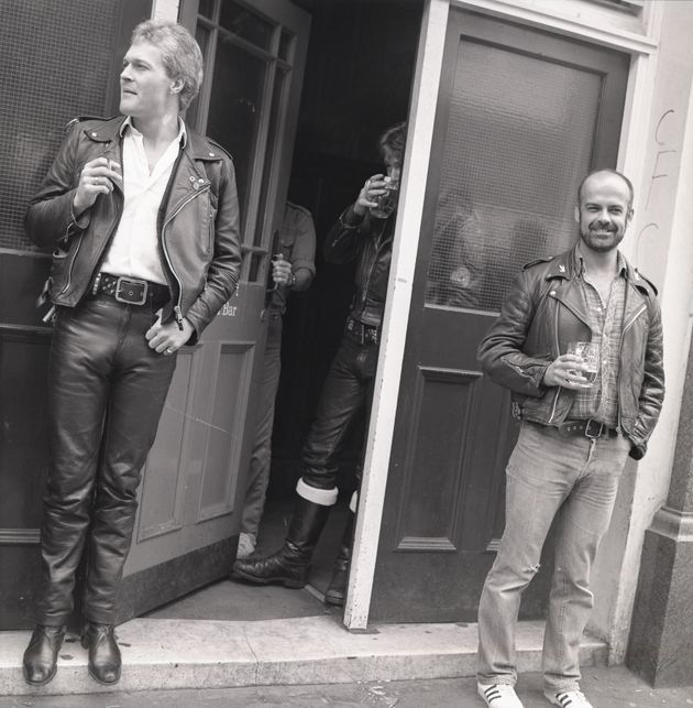 Bryan Derbyshire (holding pint), magazine editor and notable figure on the leather scene, and others outside The Coleherne, 1978