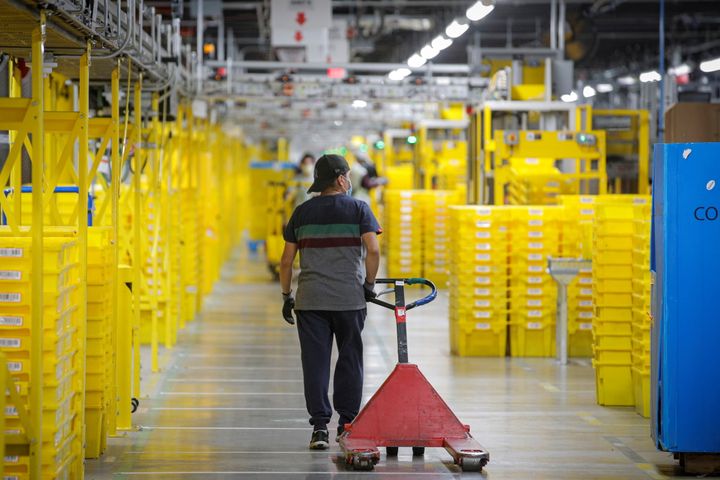 An employee pulls a cart at Amazon's JFK8 distribution center in Staten Island, New York, on Nov. 25, 2020.