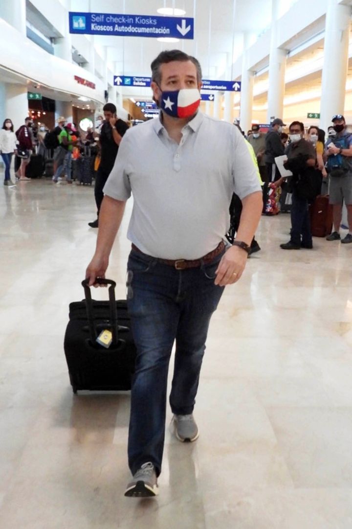 Sen. Ted Cruz (R-Texas) checks in for a flight at Cancun International Airport after a backlash over his family vacation to Mexico as his home state of Texas endured a major winter storm.